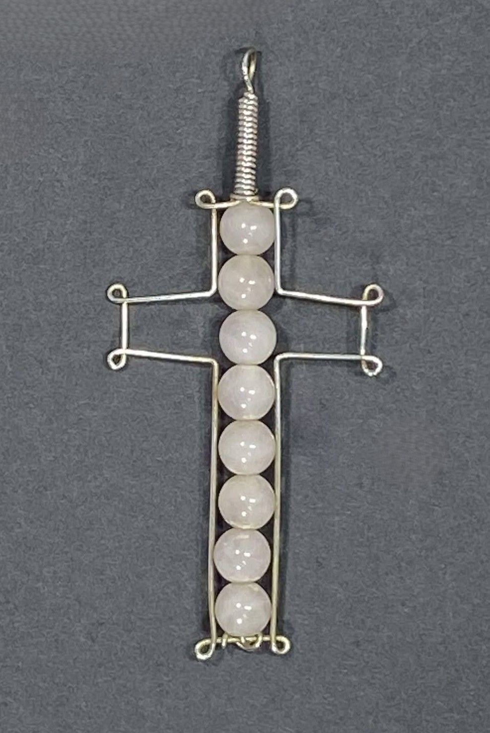 Wire cross with Rose Quartz beads.