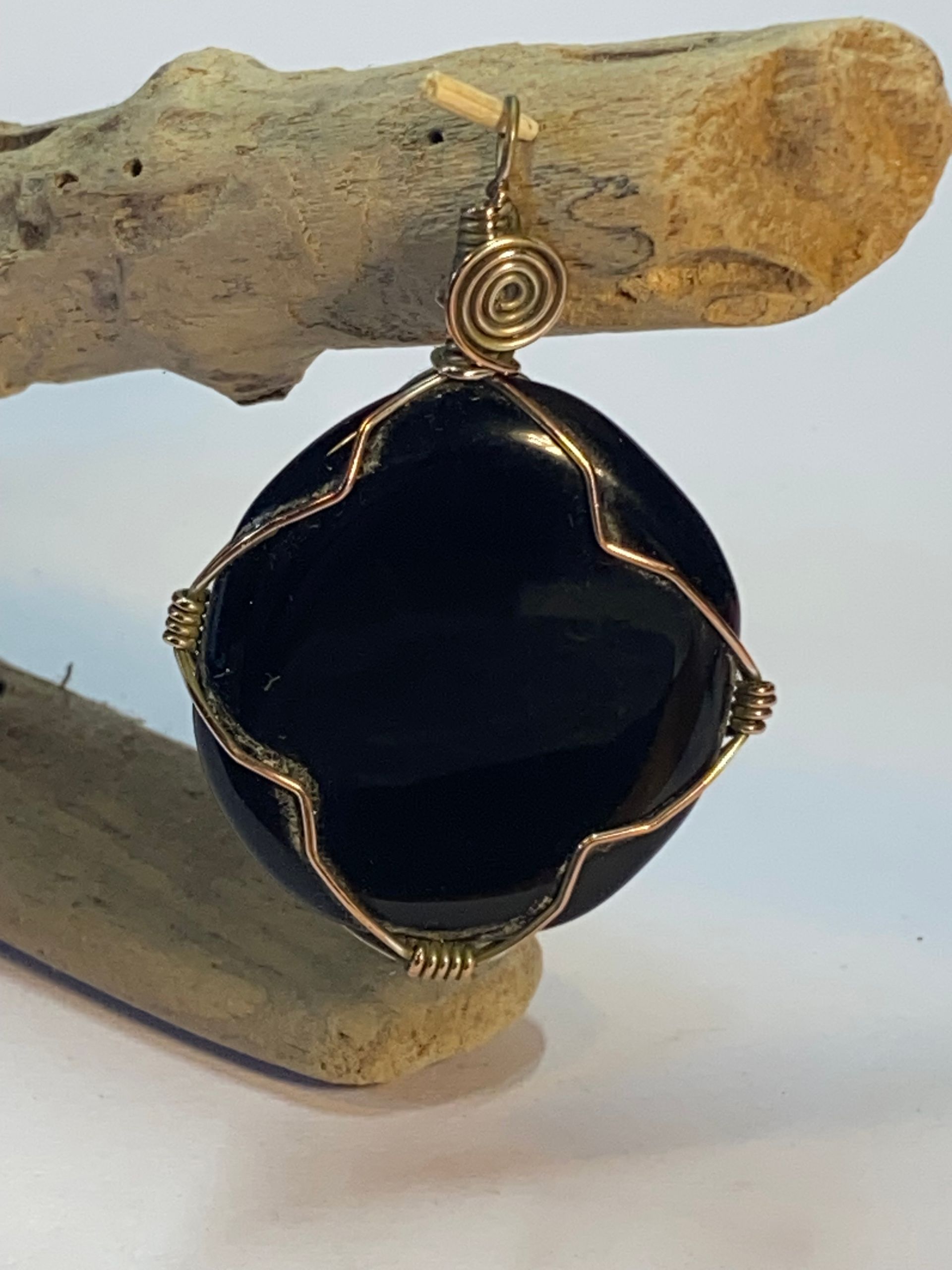 Wire wrapped Black Stone using silver plated copper wire for strength.