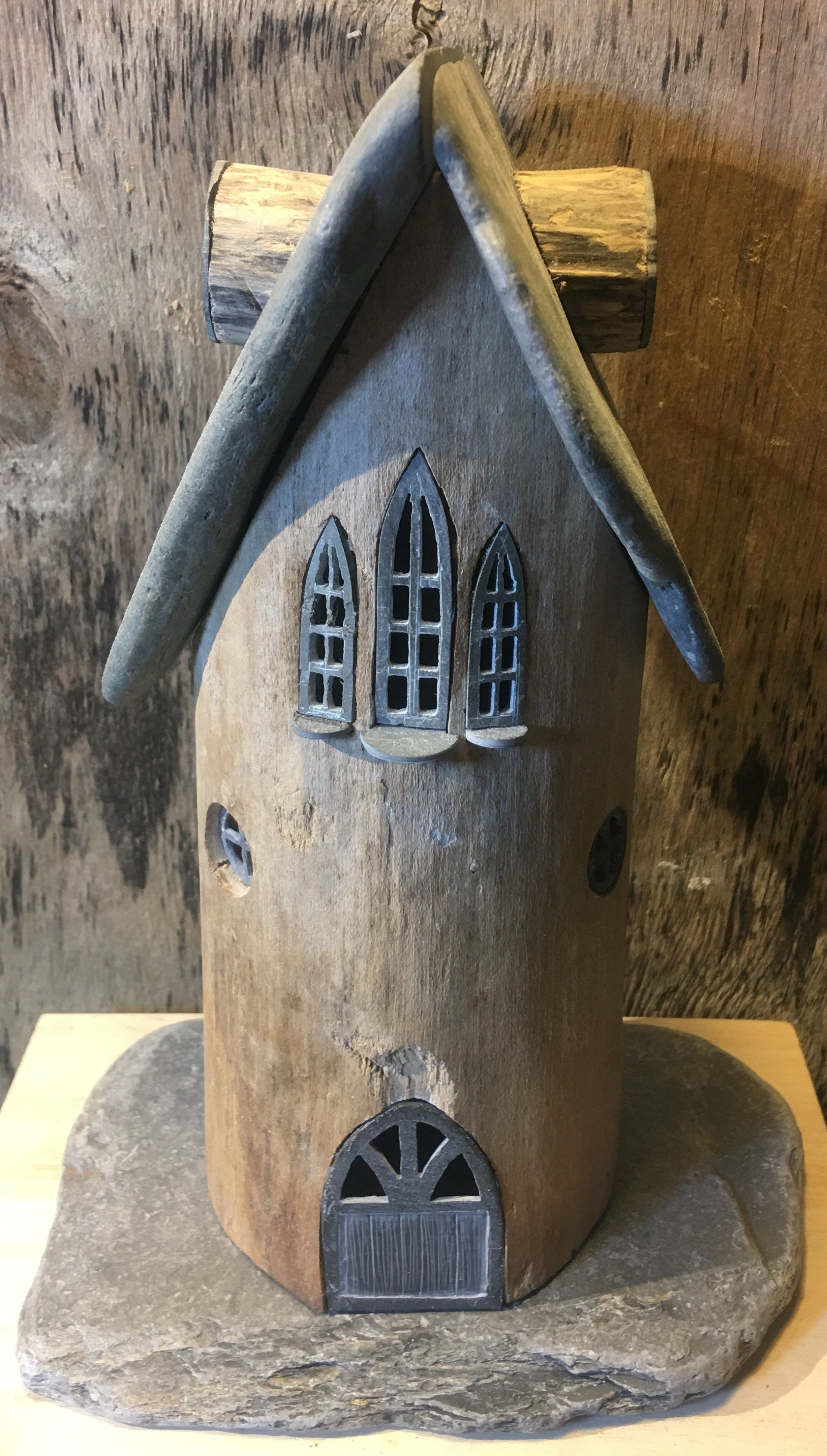 Fairy house made from hollowed out drift wood and local Devonian mudstone for the roof and windows and doors.