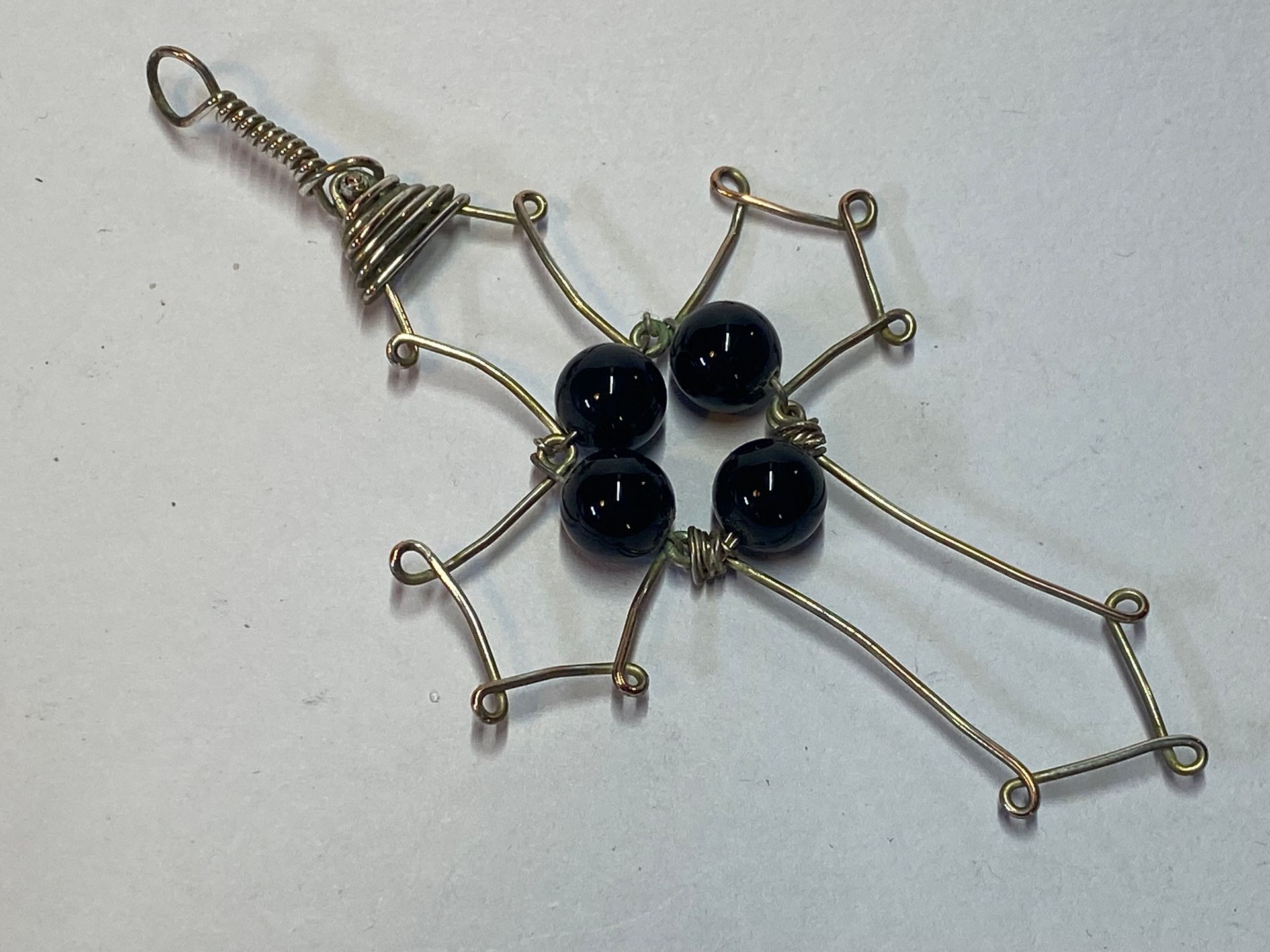 Onyx in a wire cross pendant