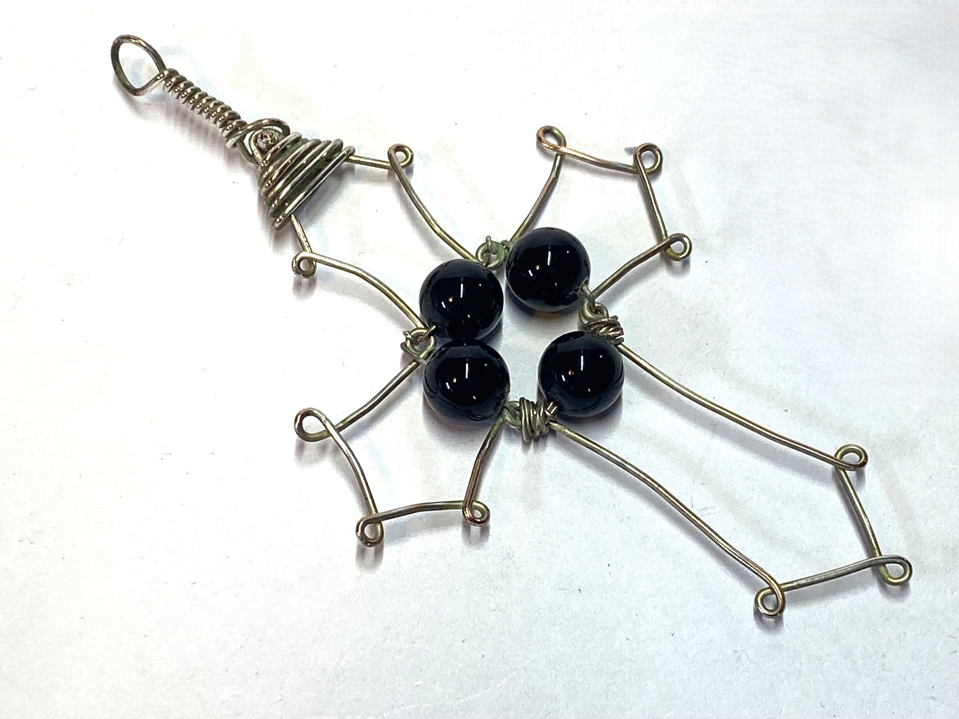 Onyx in a wire cross pendant