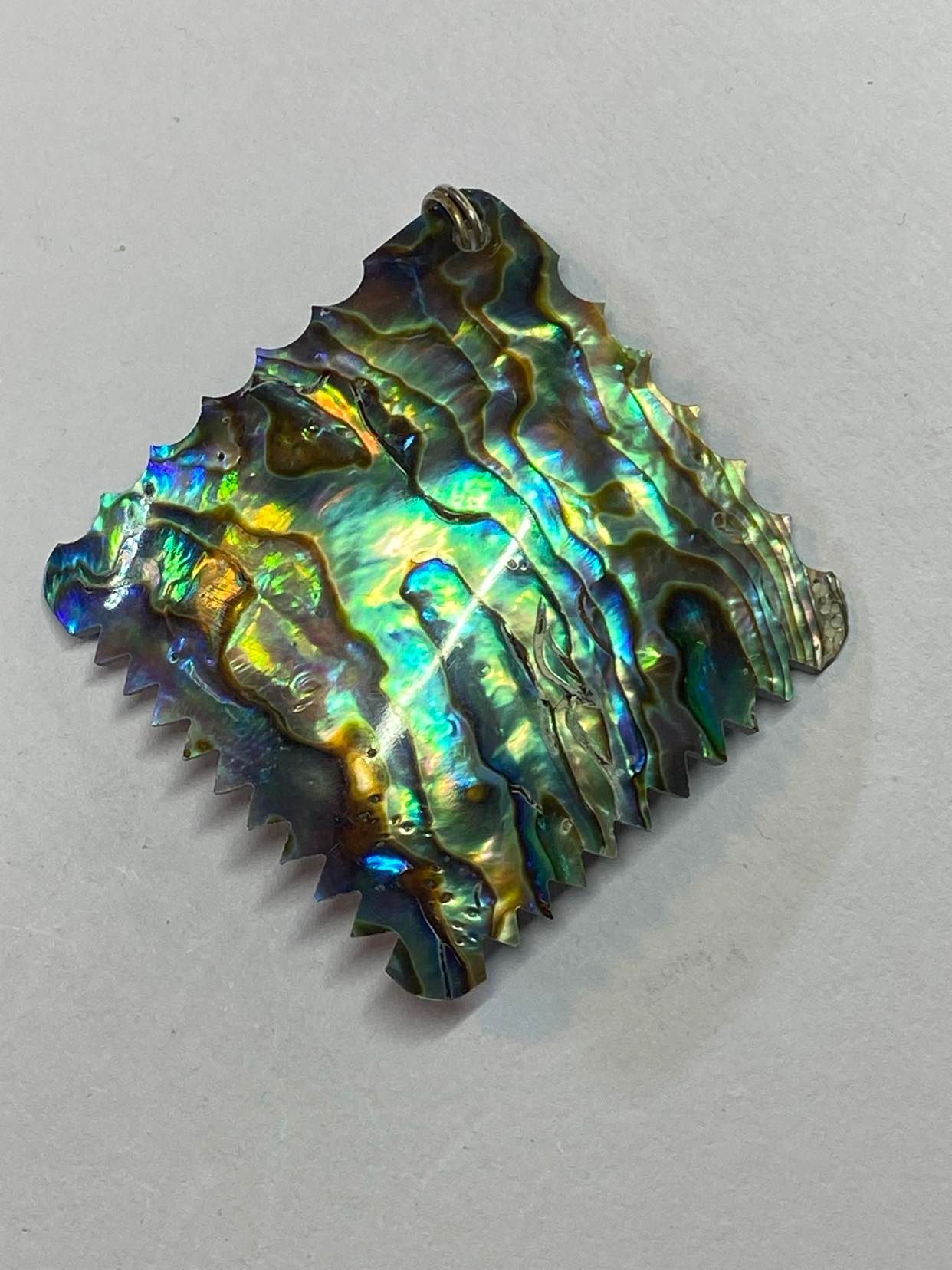 Paua Shell pendant with zig zag pattern on the edge.