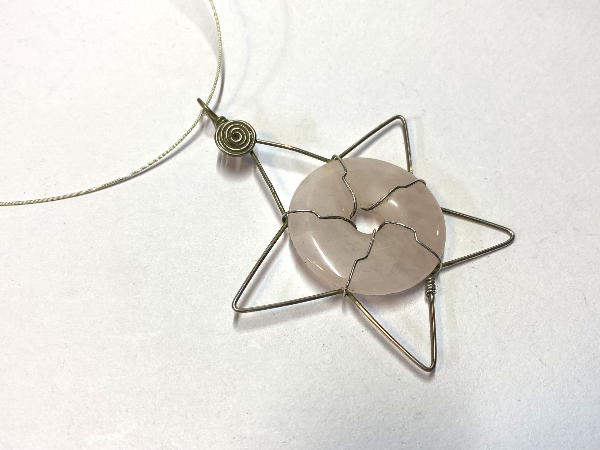 Wire wrapped Rose Quartz donut in a Silver plated copper wire star.