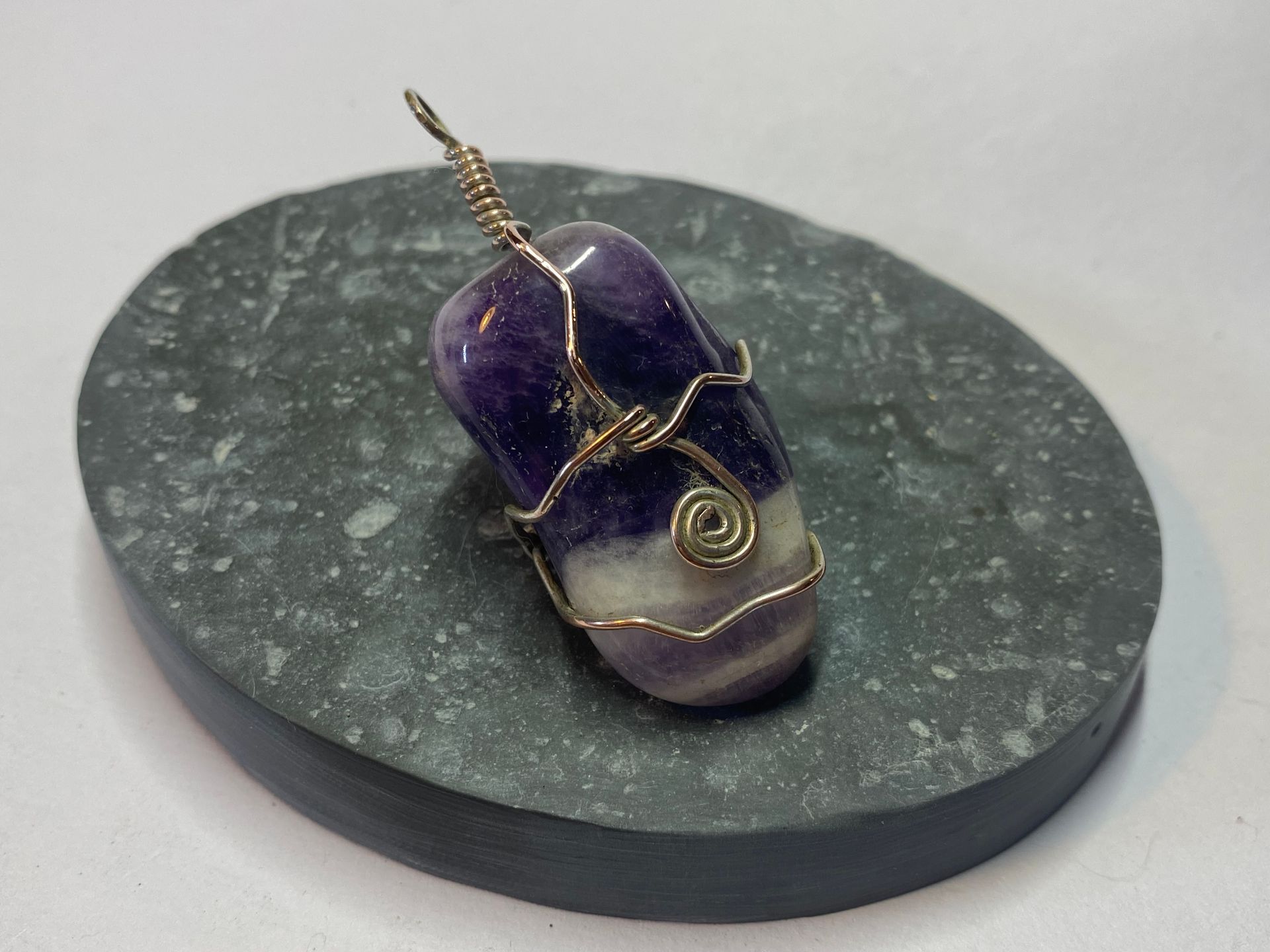 Wire wrapped tumbled Amethyst using silver plated copper wire for strength.