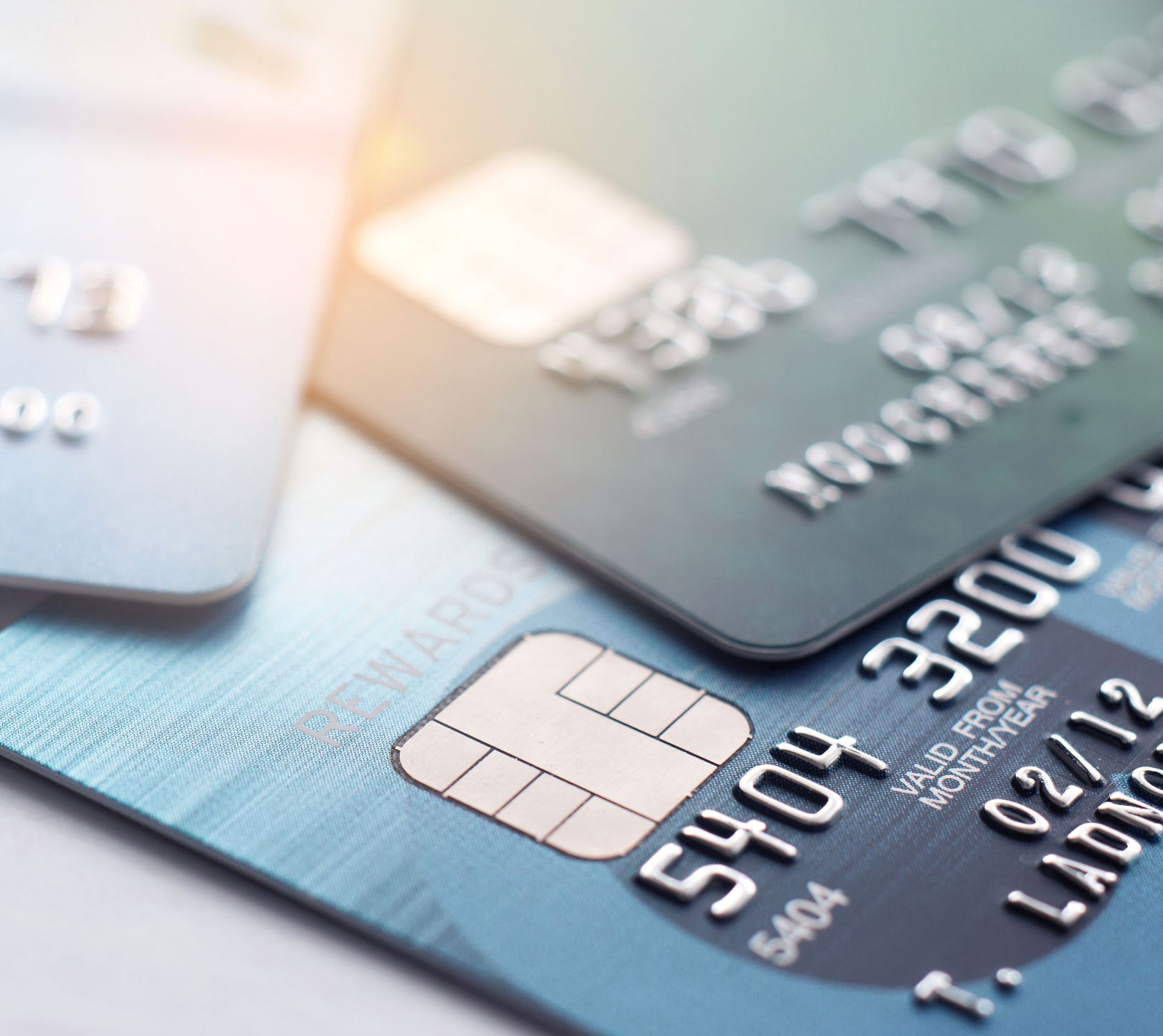 Three credit cards are stacked on top of each other
