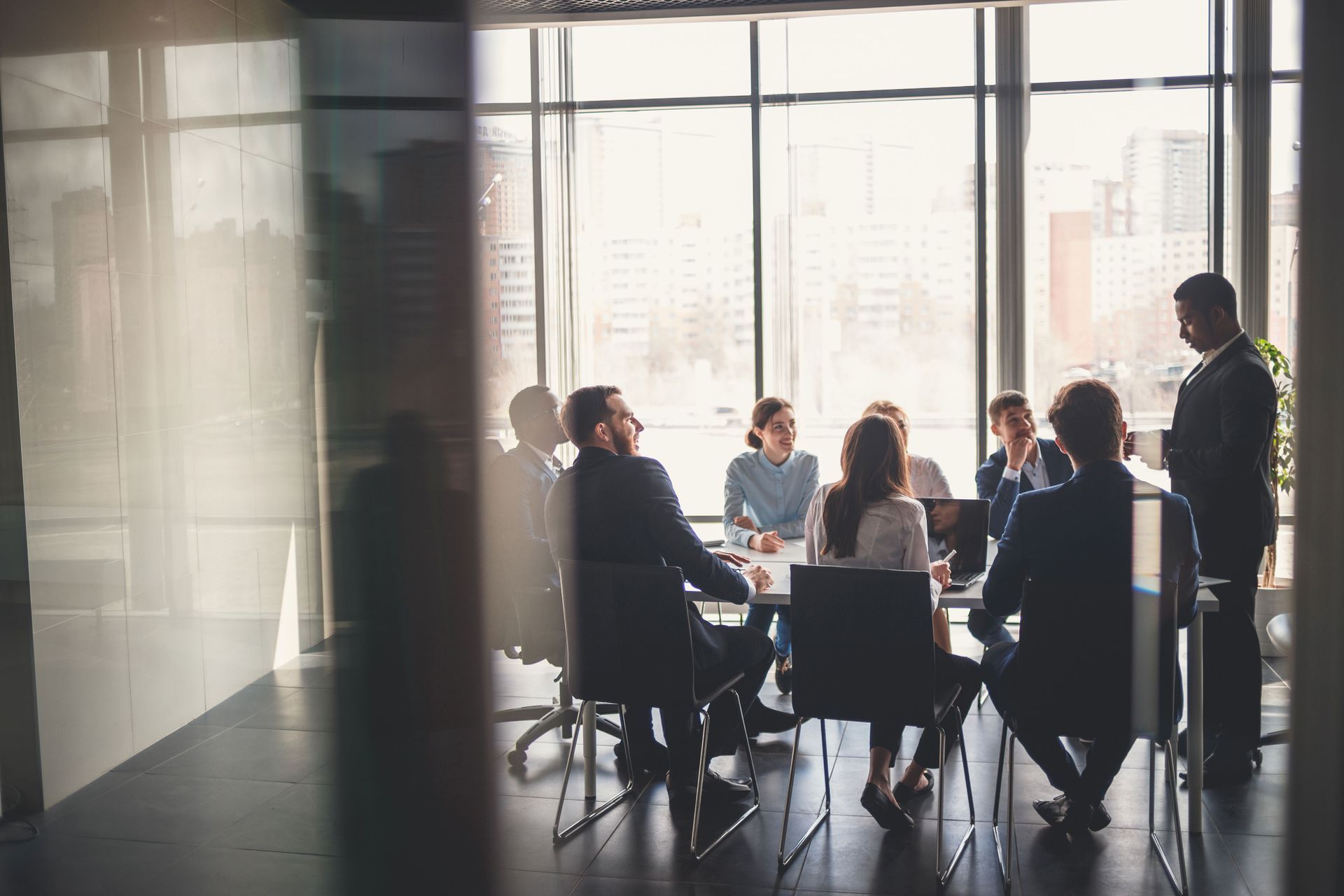A group of business people are having a meeting in a conference room.