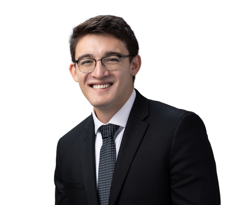 Attorney Gabe in a suit and tie is smiling for the camera.