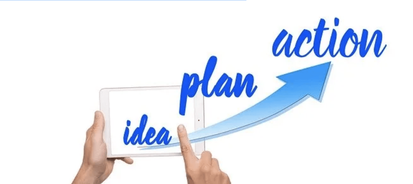 A person is holding a tablet with the words plan and action on it.