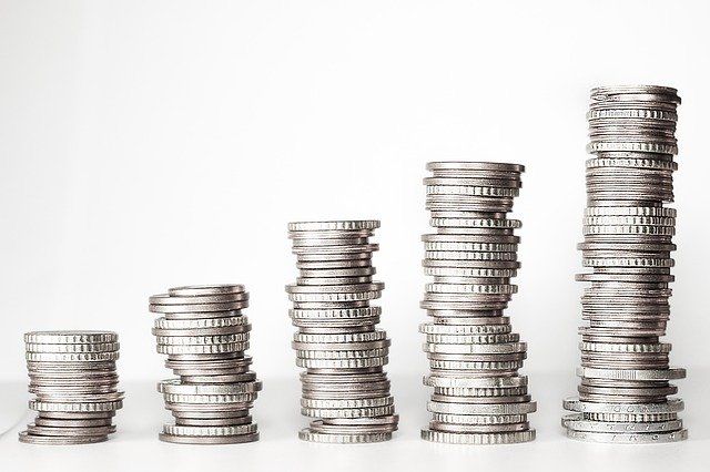 Stacks of coins are stacked on top of each other on a table.