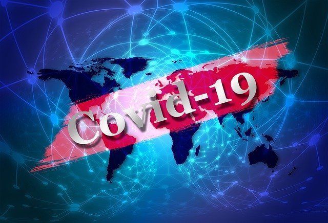 The word covid-19 is on a blue background with a map of the world.