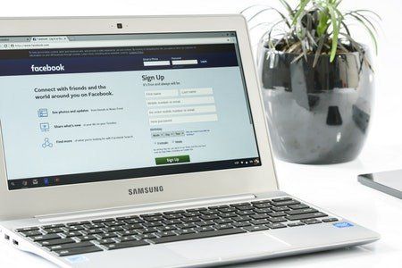 A laptop computer is open to a facebook page.