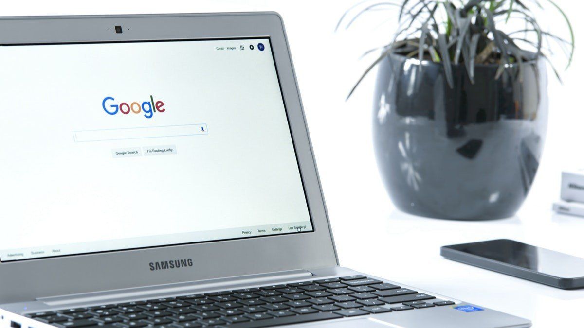 A laptop computer is open to a google search page.