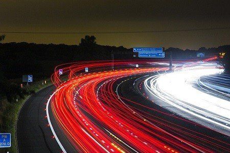 A long exposure photo of a highway at night