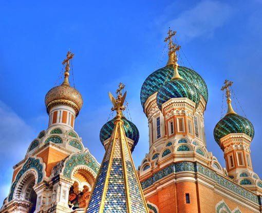 A church with a lot of domes and crosses on top of it.