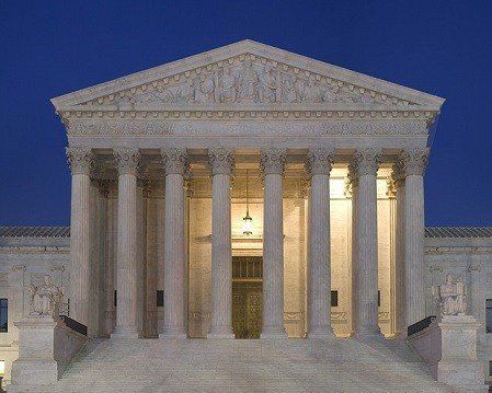 The supreme court building is lit up at night