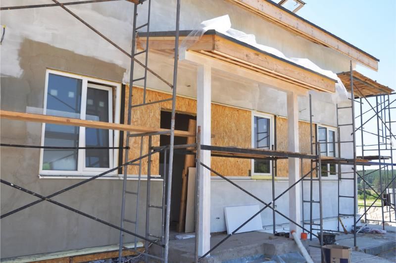 A house is being built with scaffolding around it.