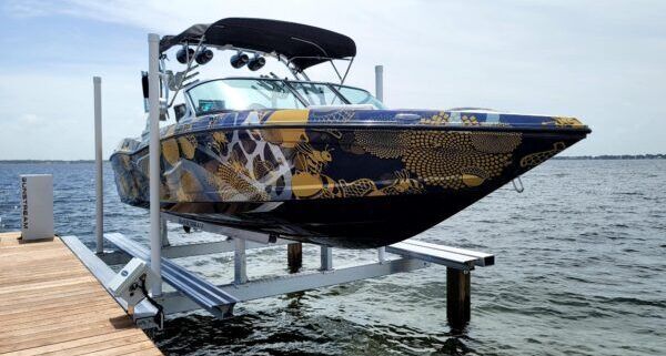 A boat is sitting on a lift in the water. Boat lift maintenance Surf City, NC