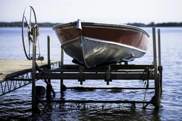 A boat is sitting on top of a boat lift in the water. Boat lift repair topsail beach nc