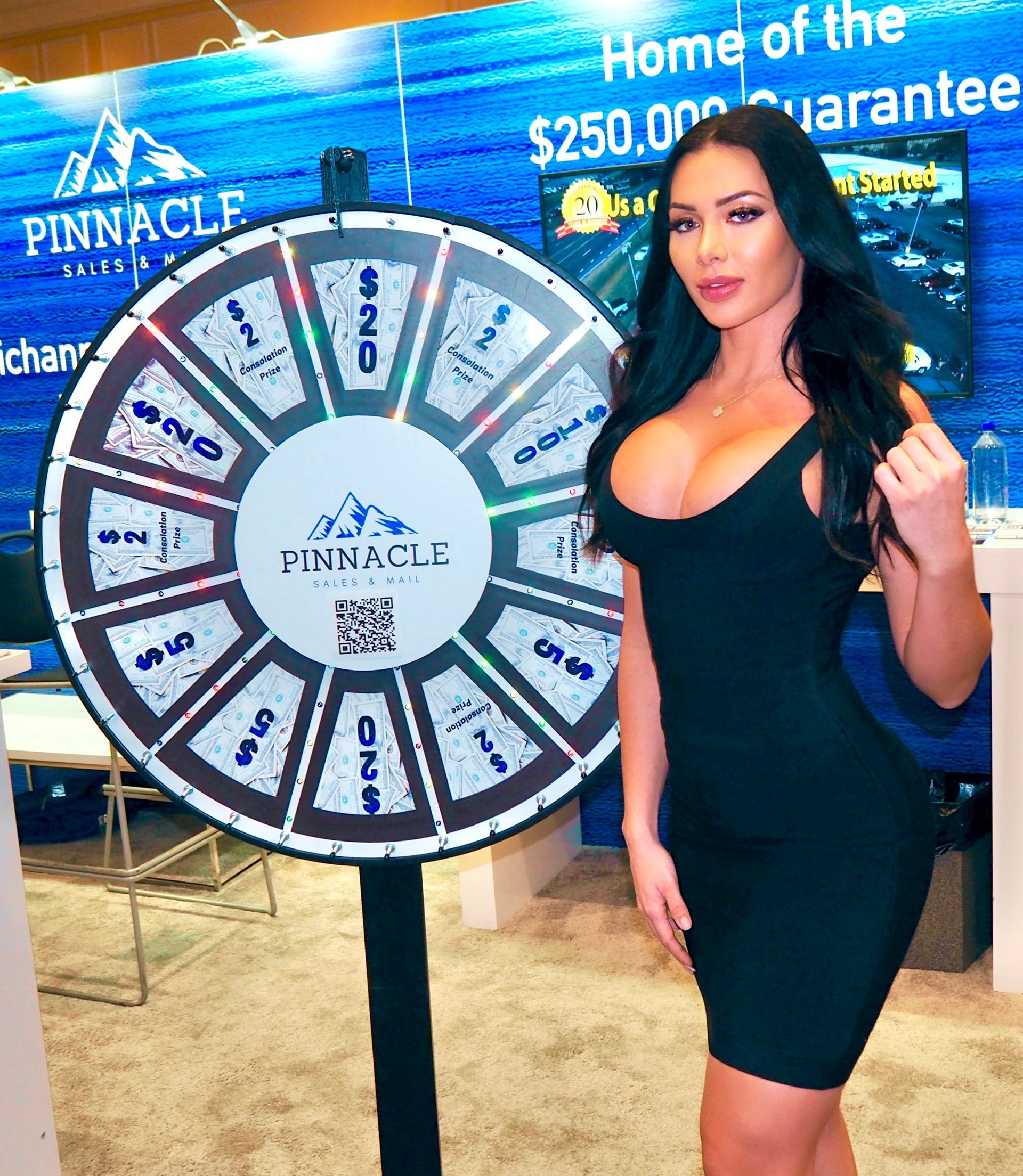 Stunning booth model in little black dress hosts the Pinnacle Sales booth at NADA show in Las Vegas.
