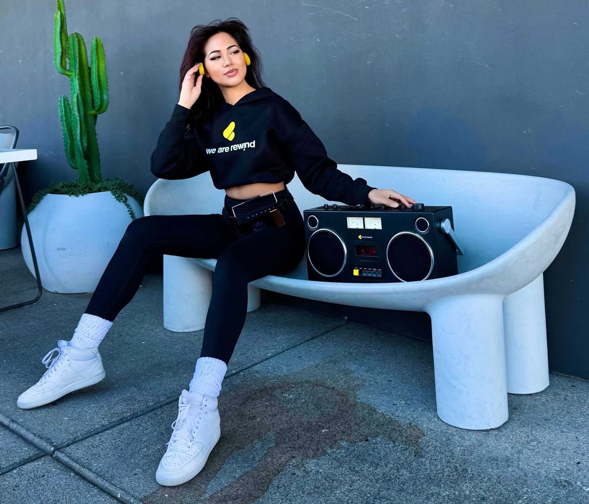 Asian promotional model showcases a retro boombox product for CES consumer electronics show in Las Vegas.