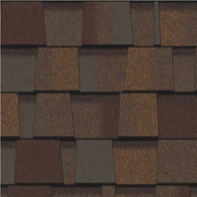 A close up of a roof with brown shingles