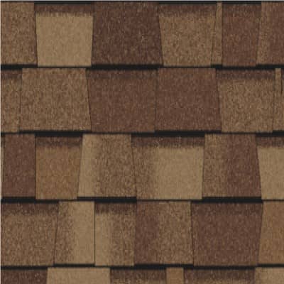 A close up of a roof with brown shingles.