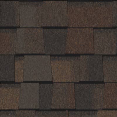 A close up of a roof with brown shingles