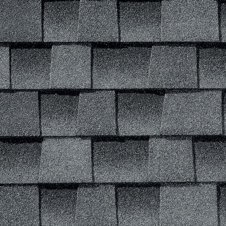 A close up of a row of gray shingles on a roof.
