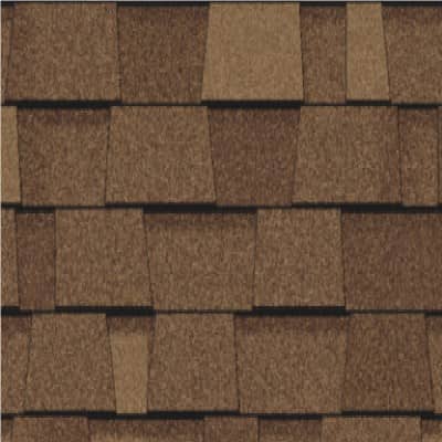 A close up of a roof with brown shingles