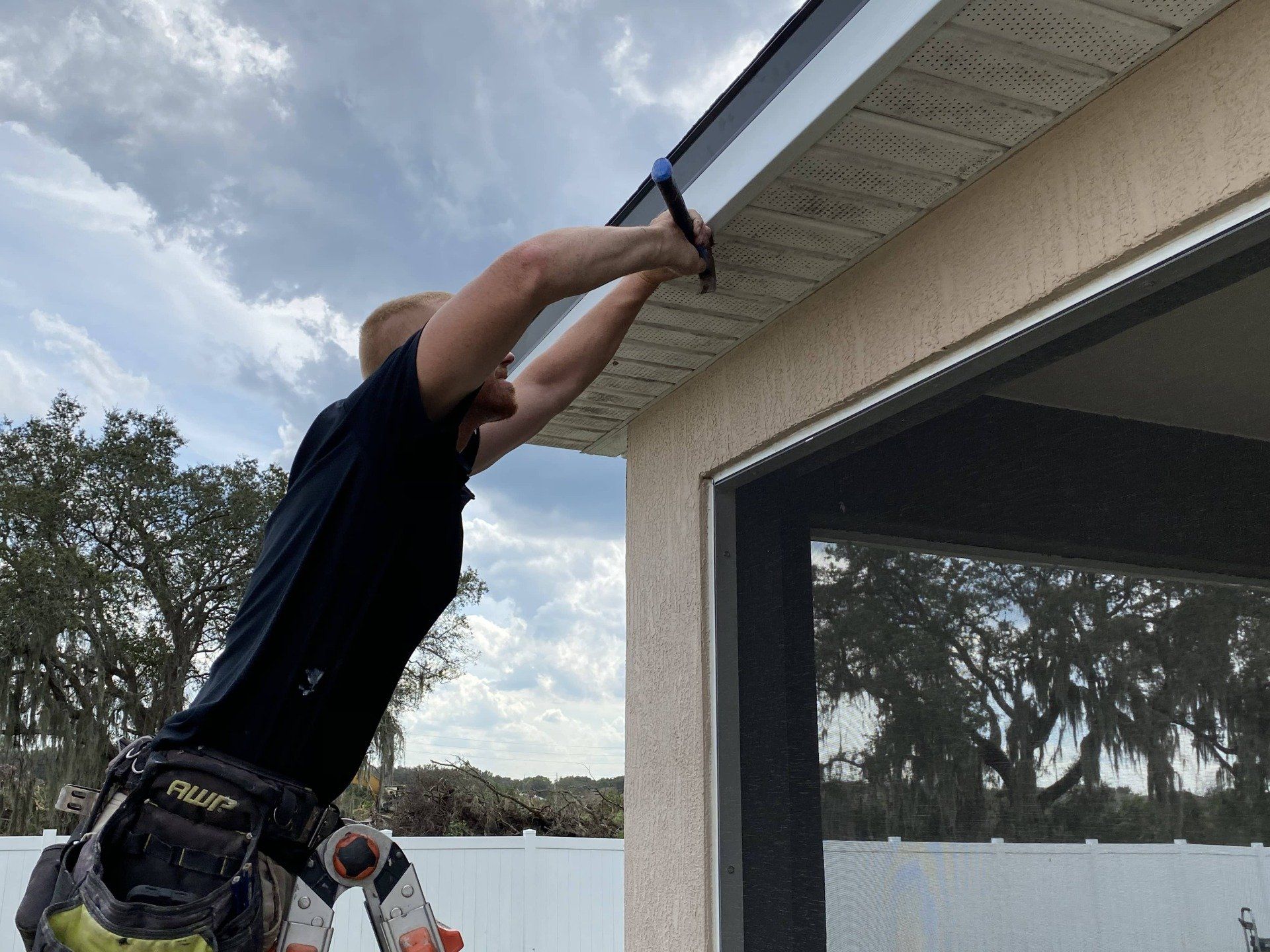 A man is working on the roof of a house