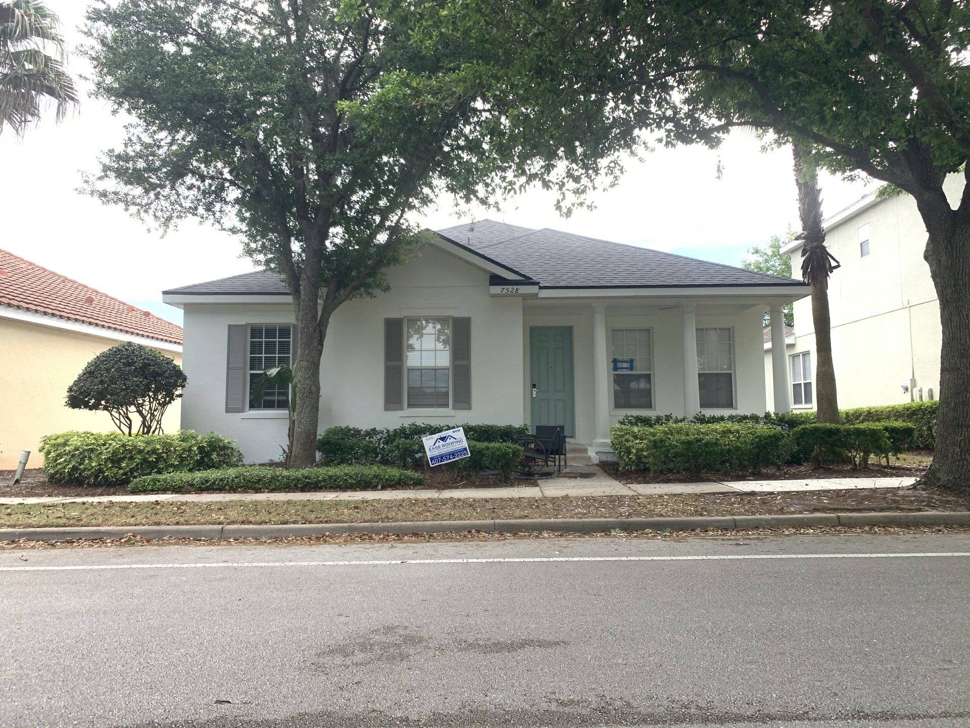 A house with a for sale sign in front of it