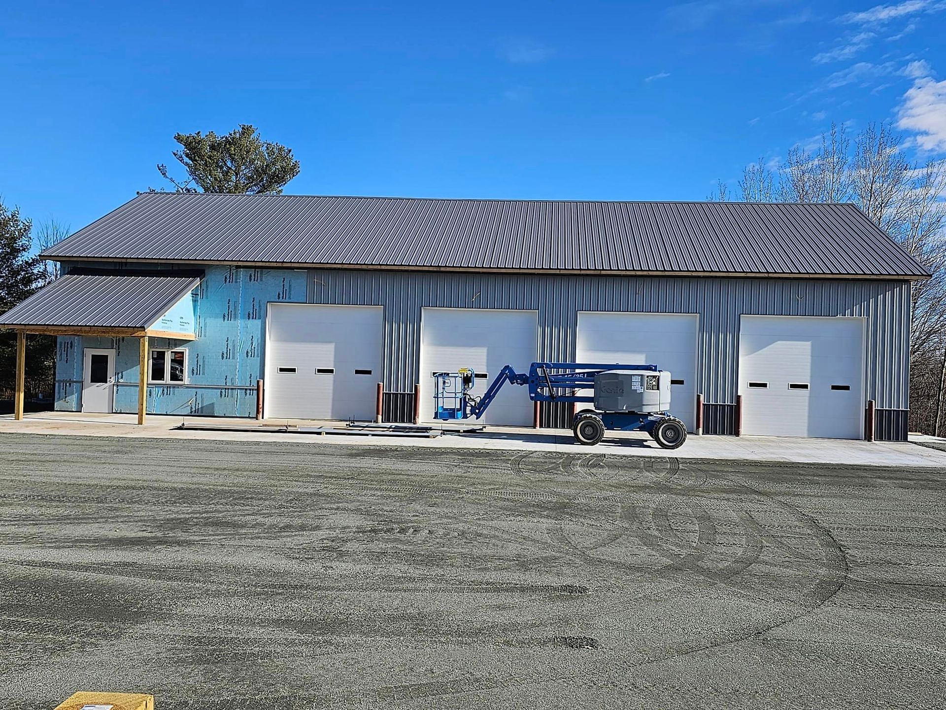 a building under construction with a tractor parked in front of it .