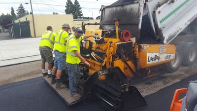 Workers Laying New Asphalt — Eugene, OR — McKenzie Excavating And Paving