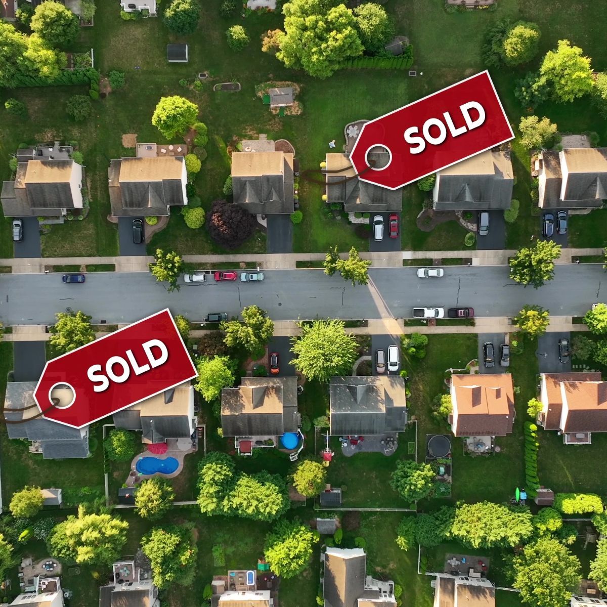 An aerial view of a residential neighborhood with two sold tags