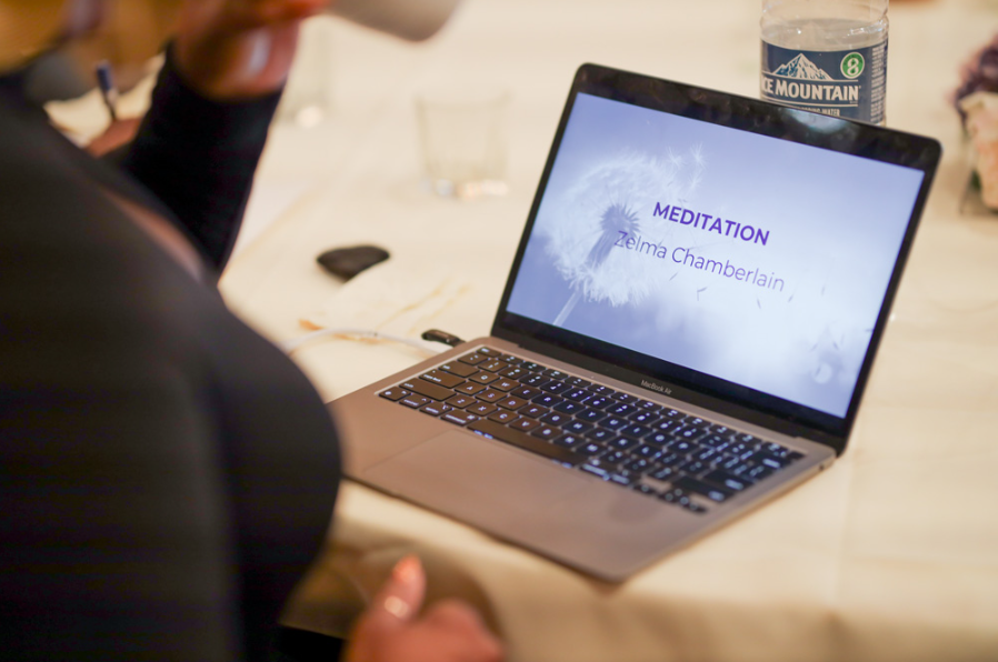 Person viewing a laptop screen showing the word