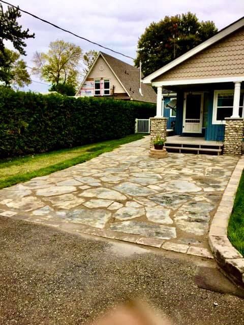 A house with a stone driveway in front of it