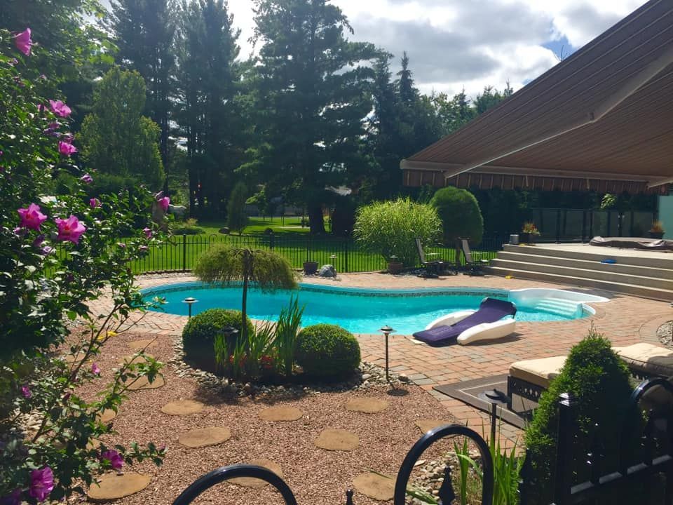 A large swimming pool in the backyard of a house
