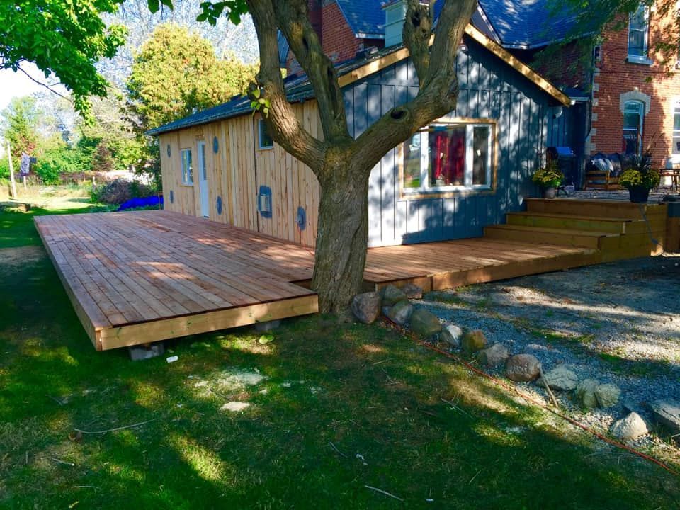 A house with a large wooden deck in front of it
