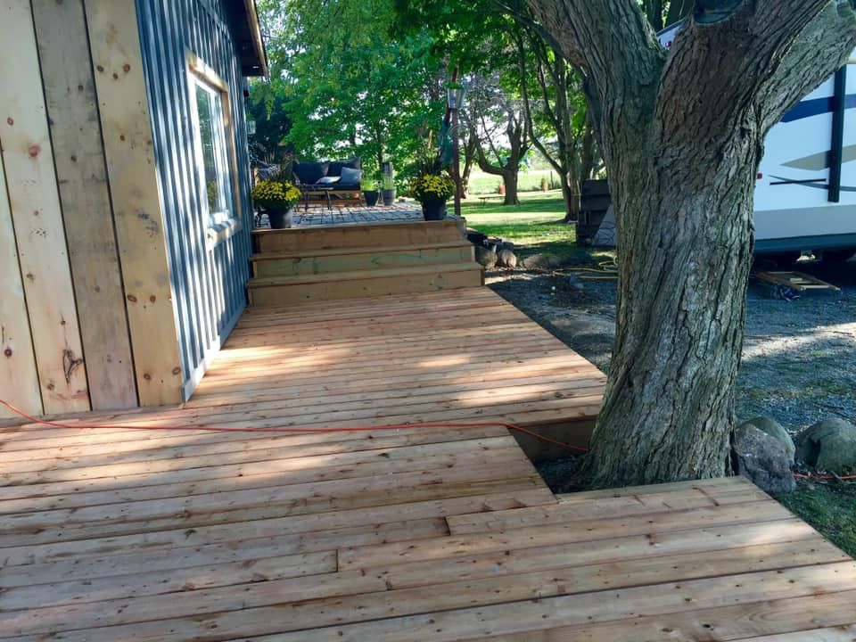 A wooden deck with stairs leading up to it