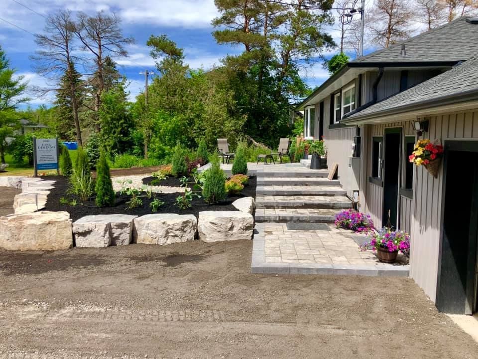 A house with a patio and stairs in front of it.