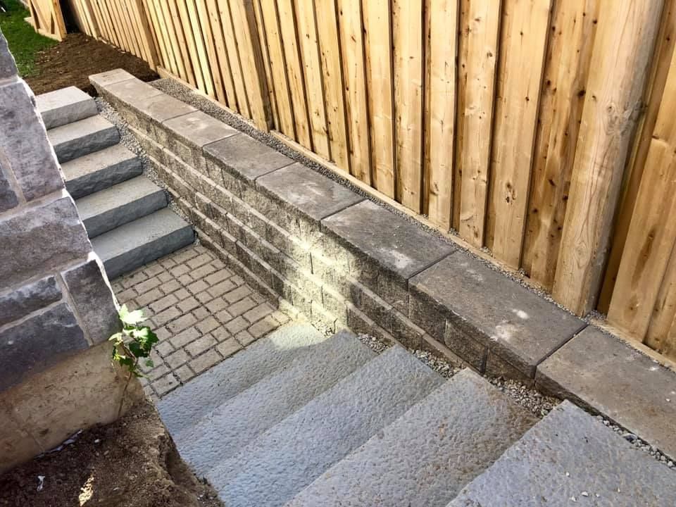 A set of stairs leading up to a wooden fence.