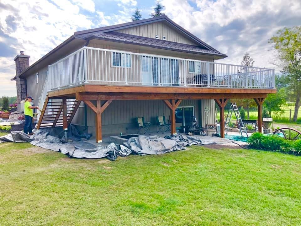 A large house with a large deck and stairs.