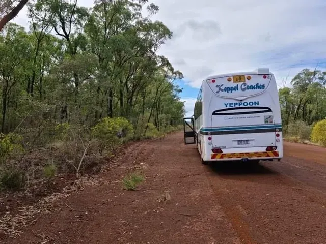 A Keppel Coaches Bus Parked on A Red Dirt Road — Keppel Coaches in Barmaryee, QLD