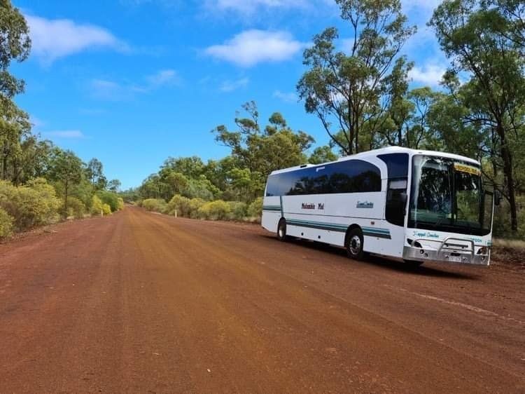 White Tour Bus Parked on a Red Dirt Road — Keppel Coaches in Barmaryee, QLD