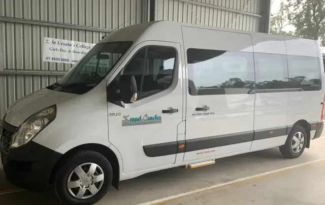 White Passenger Van Parked in A Covered Area, with A Side Door and Wheelchair Lift — Keppel Coaches in Barmaryee, QLD
