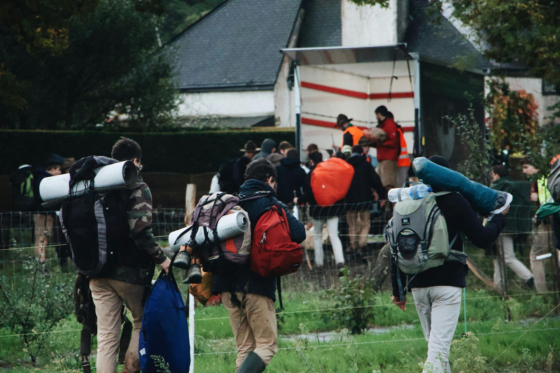 People With Backpacks Walking Near a Building — Keppel Coaches in Barmaryee, QLD