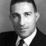 Portrait of a man in a suit, looking forward. Black and white.