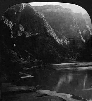 River flowing through a canyon with steep rock walls, possibly the Grand Canyon.