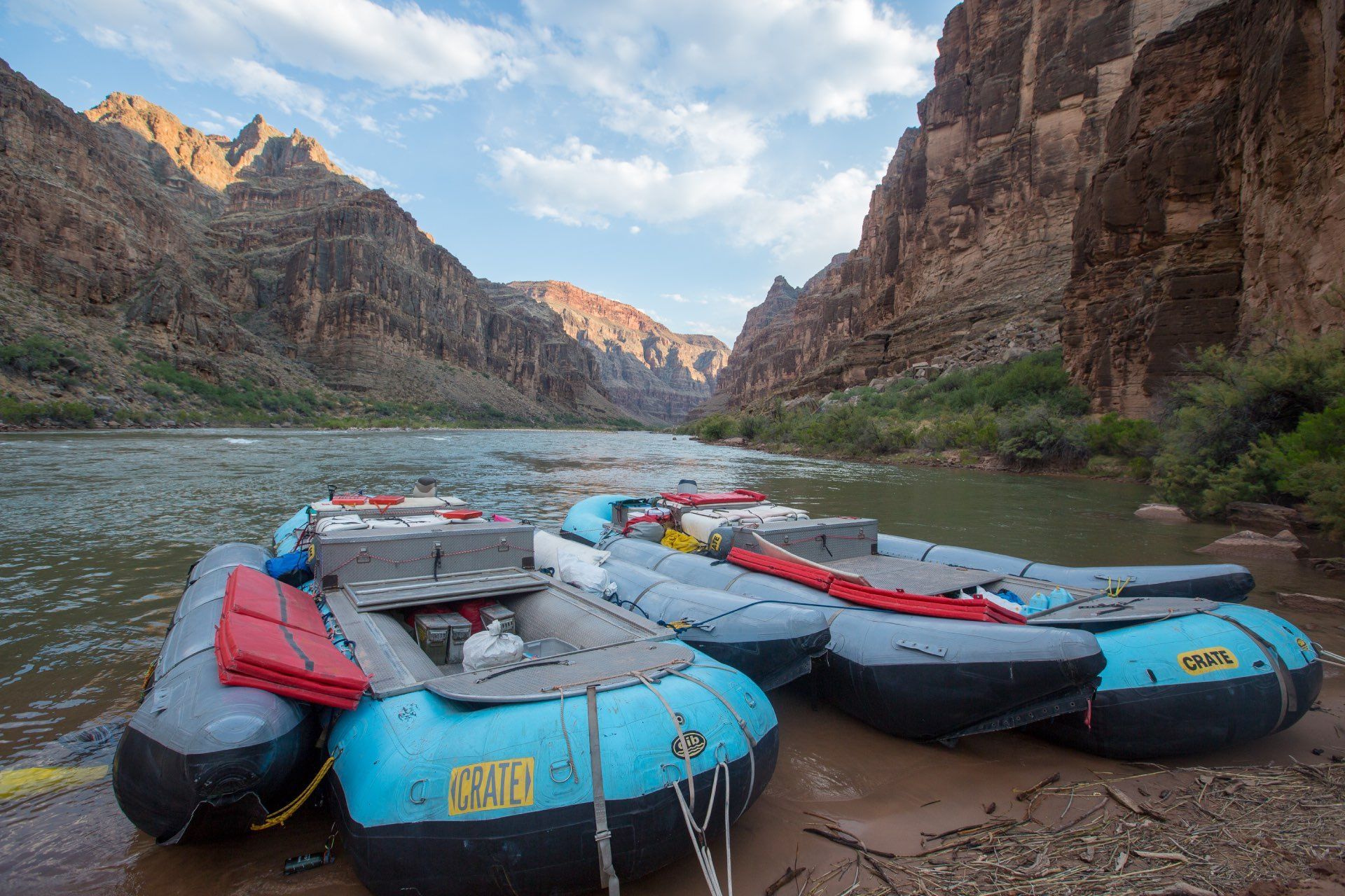 Rafts lined up on riverbank in canyon