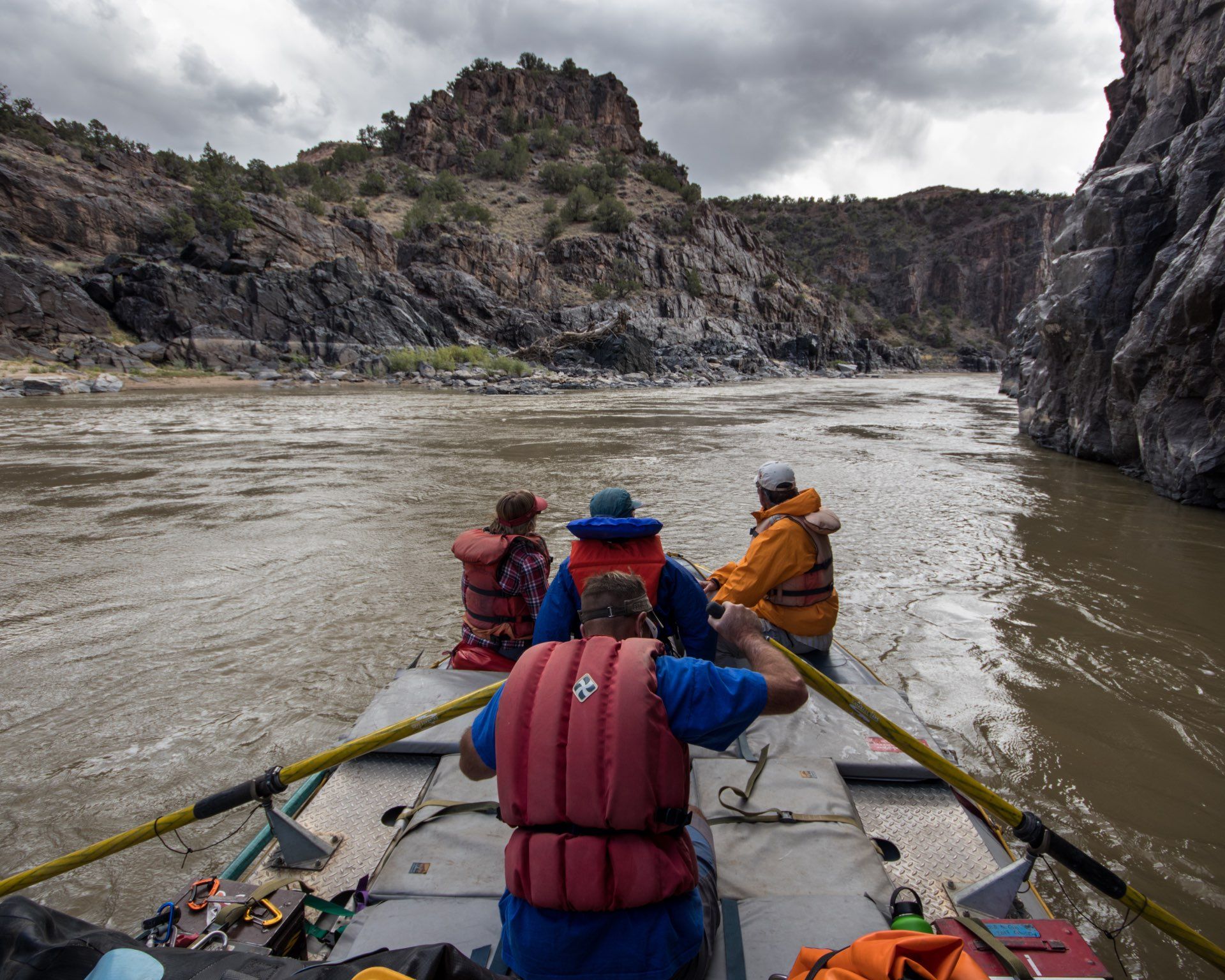 Rafting on a muddy river through a canyon